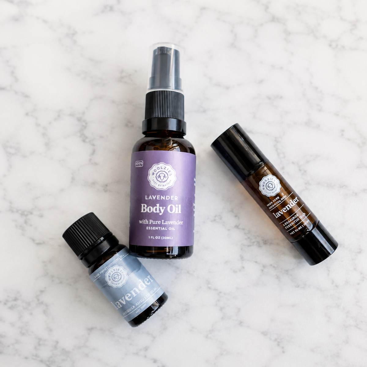 Three lavender essential oil products from Woolzies: a lavender body oil, a lavender essential roll-on and a lavender essential oil
