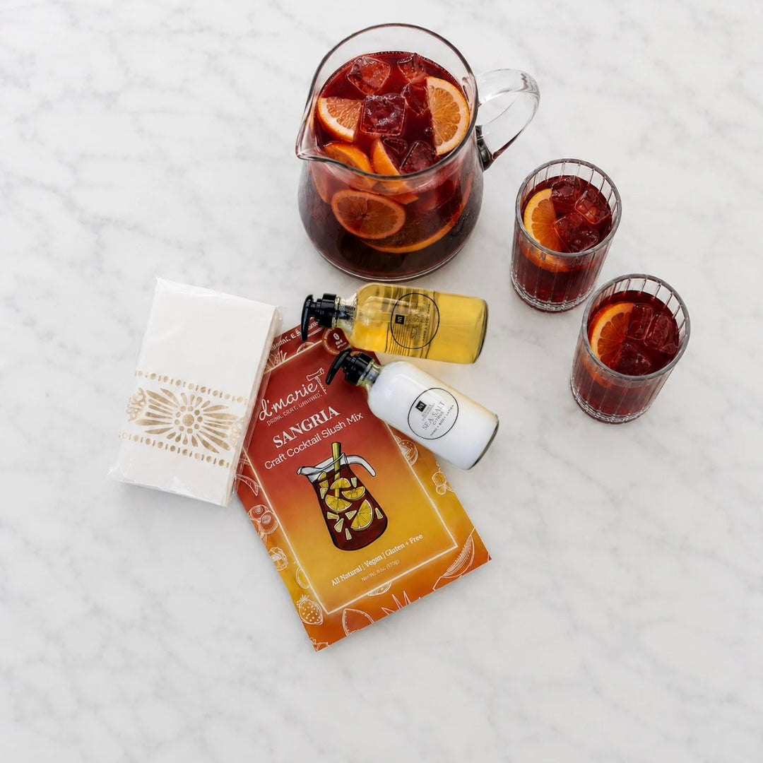 A housewarming curated gift collection including sea-salt citrus scented hand wash and lotion with bamboo tray, Moroccan pattern guest napkins and sangria cocktail slush mix. Beautifully arranged in a floral gift box with a satin ribbon.